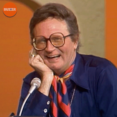 Man With Glasses And Scarf Smiling At Microphone Buzzr GIF