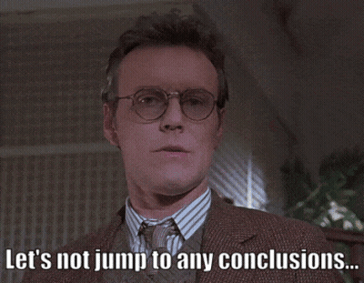 Man With Glasses And Suit Says Let's Not Jump To Any Conclusions GIF