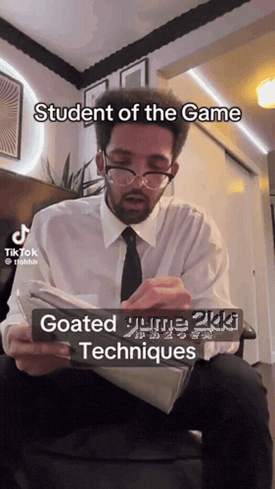Man With Glasses And Tie Reading Student Of The Game GIF