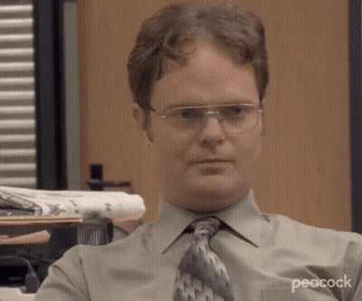 Man With Glasses And Tie Sitting At Desk GIF