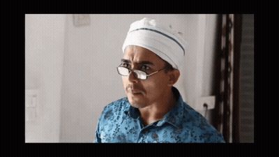 Man With Glasses And White Hat Looking Left GIF
