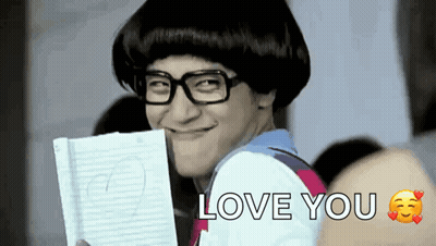 Man With Glasses And Wig Holding Paper And Smiling GIF