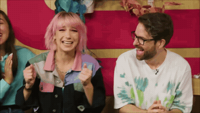 Man With Glasses And Woman With Pink Hair Laughing GIF