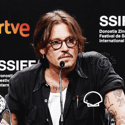 Man With Glasses At Microphone With Ssiff Sign GIF