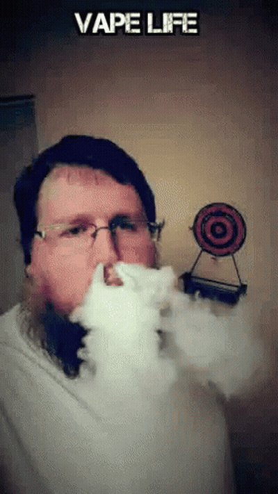 Man With Glasses Blowing Smoke At Vape Life Target GIF