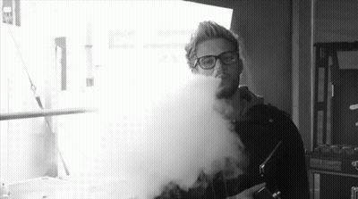 Man With Glasses Blowing Smoke Black And White GIF