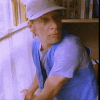 Man With Glasses Blue Shirt Holding Paper WS GIF