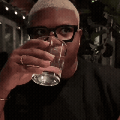 Man With Glasses Drinking From Glass