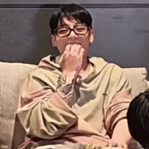 Man With Glasses Eating On Couch GIF