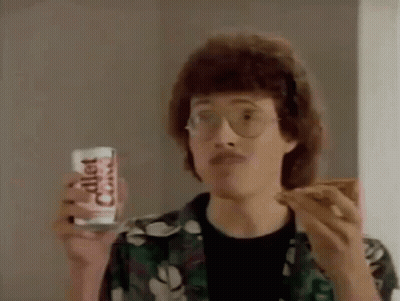 Man With Glasses Eating Pizza And Holding Diet Coke GIF