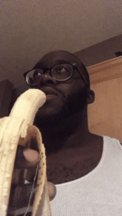 Man With Glasses Holding Banana In Mouth GIF