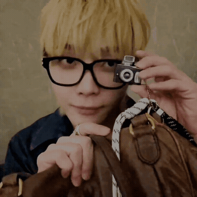 Man With Glasses Holding Camera Saying Oi GIF