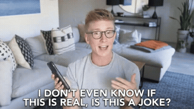 Man With Glasses Holding Cell Phone Saying I Don't Even Know If This Is Real GIF