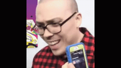 Man With Glasses Holding Cell Phone Smiling GIF