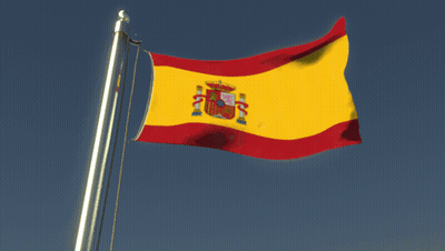 Man With Glasses Holding Flag In Front Of Green And Red Flag GIF