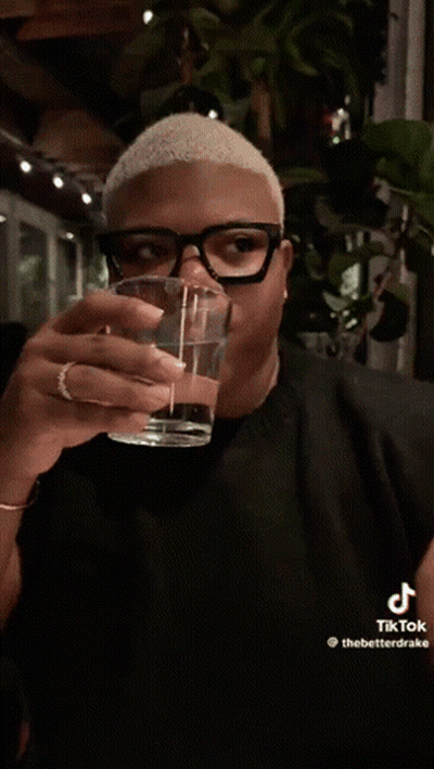 Man With Glasses Holding Glass of Water