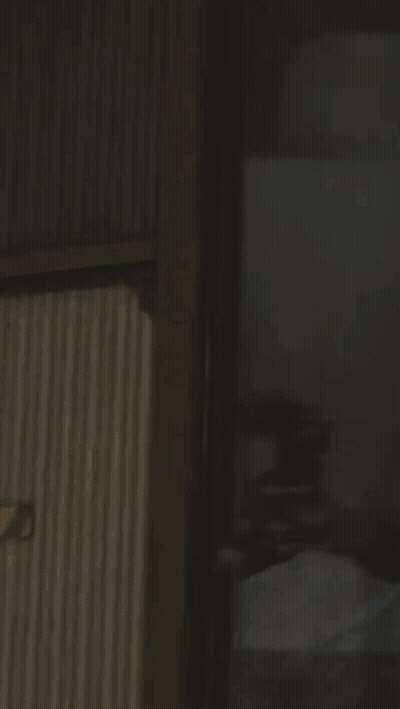 Man With Glasses Holding Gun Blue Light GIF
