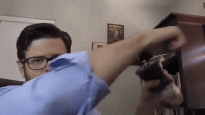 Man With Glasses Holding Gun GIF