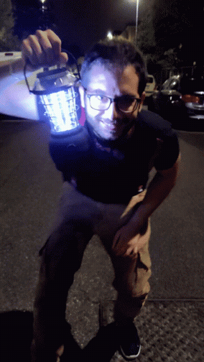Man With Glasses Holding Lantern GIF