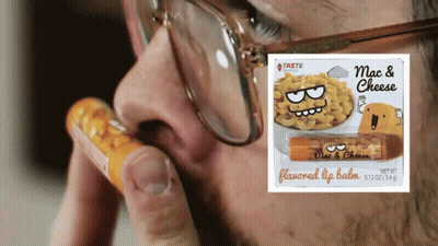 Man With Glasses Holding Mac And Cheese Lip Balm GIF