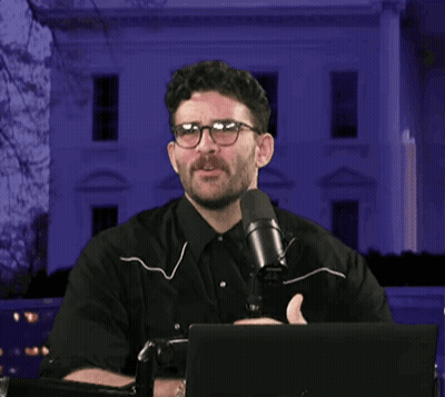 Man With Glasses Holding Microphone GIF