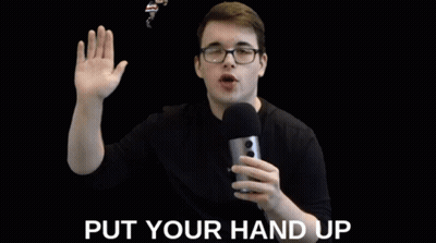 Man With Glasses Holding Microphone Saying Put Your Hand Up GIF