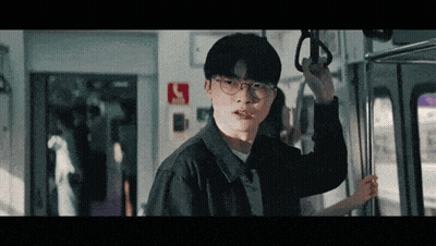 Man With Glasses Holding Railing On Train GIF