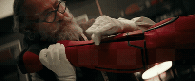 Man With Glasses Holding Red Item With Measuring Tape GIF