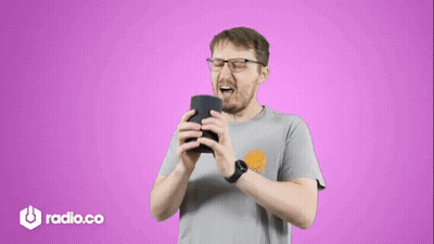 Man With Glasses Holding Speaker In Front Of Purple Background Saying Radio.co GIF