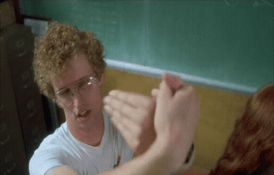 Man With Glasses Holding Woman's Hand In Classroom GIF