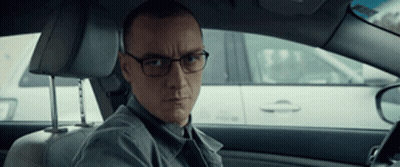 Man With Glasses In Driver's Seat Looking At Camera GIF