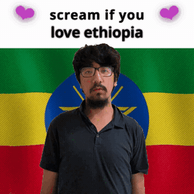 Man With Glasses In Front Of Ethiopian Flag GIF