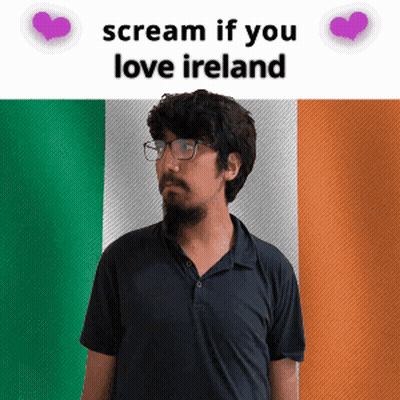 Man With Glasses In Front Of Irish Flag GIF