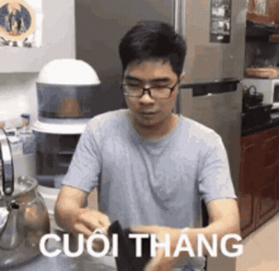 Man With Glasses In Kitchen Foreign Language Shirt GIF