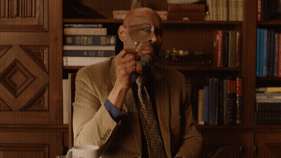 Man with Glasses Looking at Cell Phone