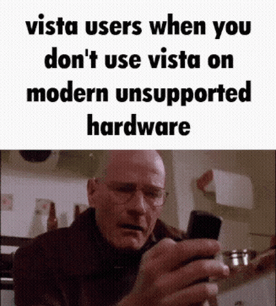 Man With Glasses Looking At Cell Phone Saying Vista Users When You Don't Use Vista On Modern Unsupported GIF