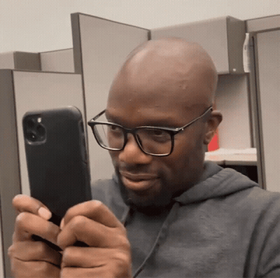Man With Glasses Looking At Phone GIF