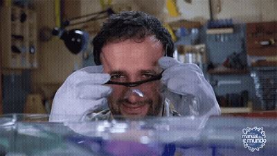 Man With Glasses Looking Through Magnifying Glass Manual El Mundo GIF
