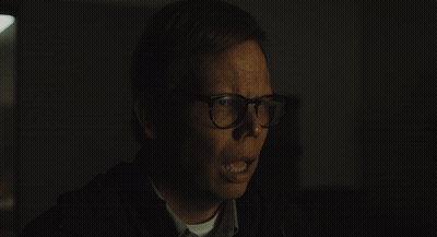 Man With Glasses Making Funny Face In Dark GIF