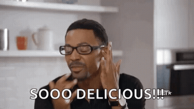 Man With Glasses Making Funny Face Saying Sooo Delicious GIF