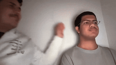 Man With Glasses Next To Man In E Sweatshirt GIF