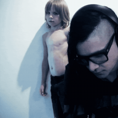 Man With Glasses Next To Shirtless Boy GIF