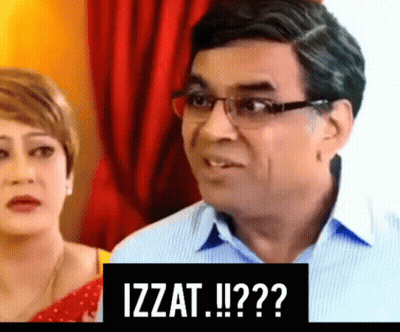 Man With Glasses Next To Woman And Izzat Sign GIF