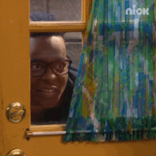 Man With Glasses Peeking Behind The Door Window GIF