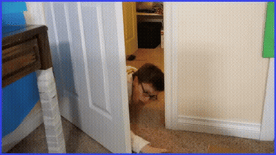 Man With Glasses Peeking Out of Doorway