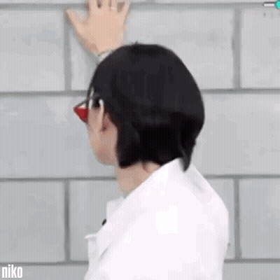 Man With Glasses Red Nose Hand On Brick Wall GIF