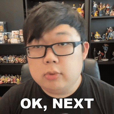 Man With Glasses Saying Ok Next With Figurine Shelf GIF