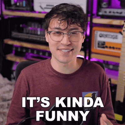 Man With Glasses Says It's Kinda Funny At Microphone GIF