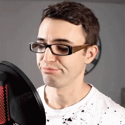 Man With Glasses Singing Into Microphone Making Face GIF