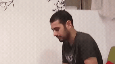 Man With Glasses Sitting At Desk With Tissues GIF